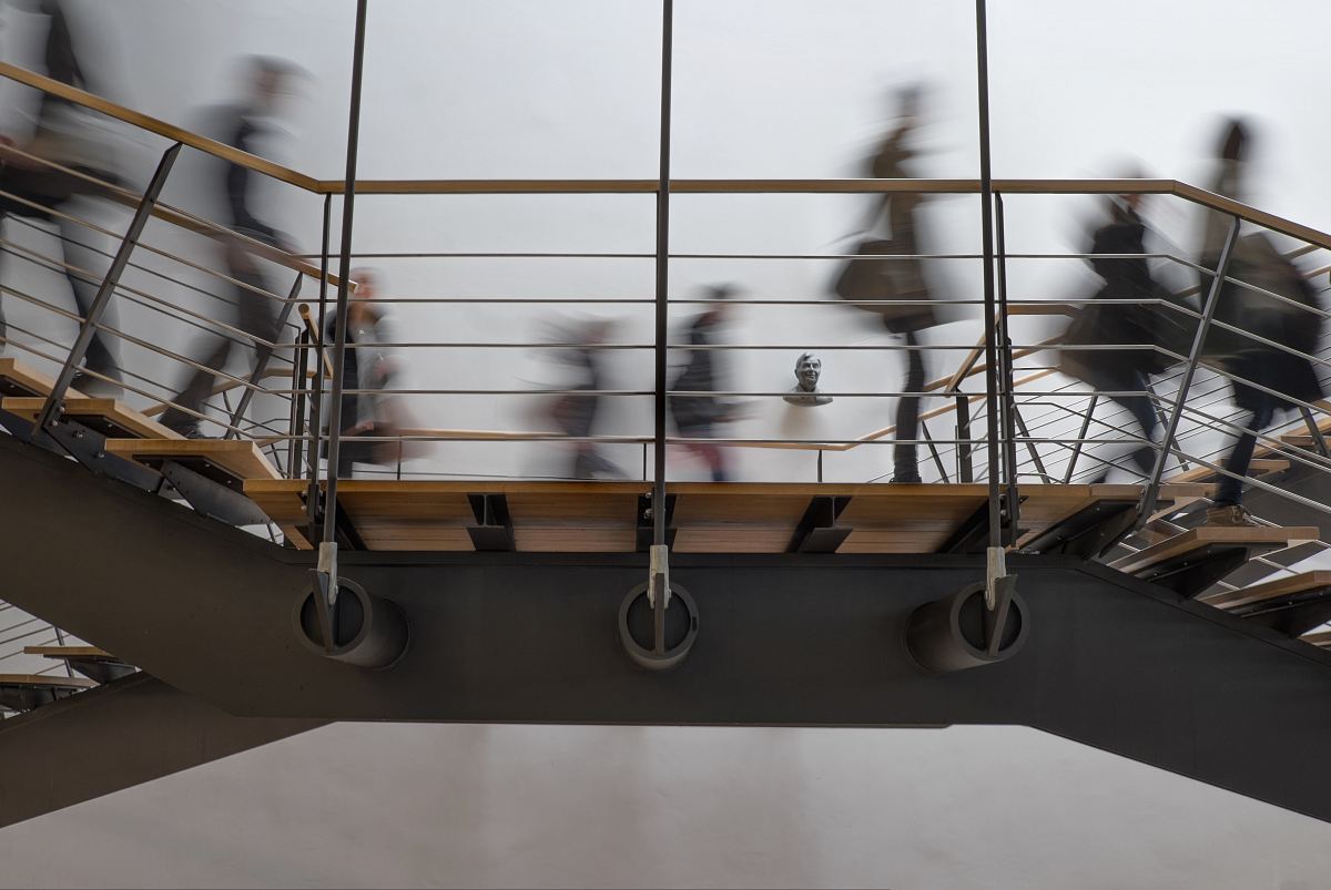 time lapse photography of people passing on bridge